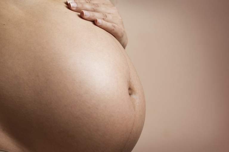 The image of a pregnant woman's stomach.